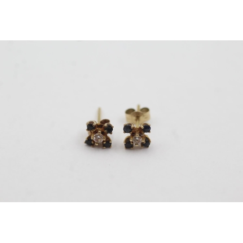 1033 - A pair of 9ct gold diamond and sapphire stud earrings - approx. gross weight 0.5 grams