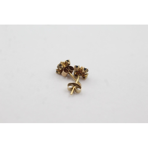 1033 - A pair of 9ct gold diamond and sapphire stud earrings - approx. gross weight 0.5 grams