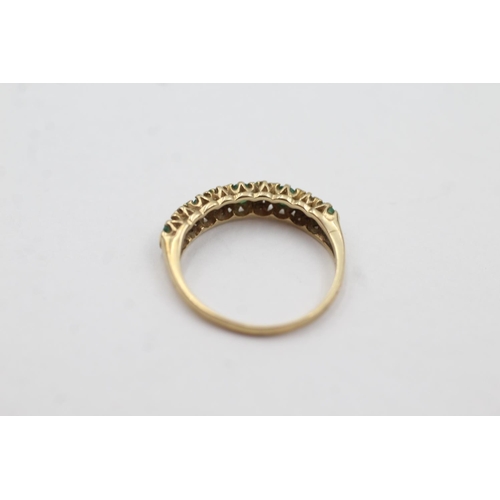 1043 - A 9ct gold emerald and diamond half-eternity ring, size J - approx. gross weight 1.3 grams