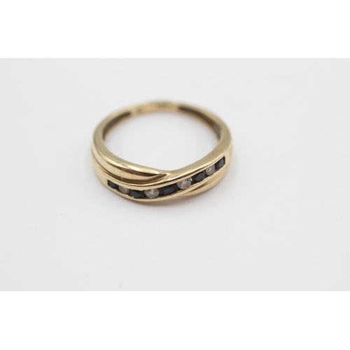 1048 - A hallmarked London 9ct gold sapphire and clear gemstone channel set ring, size M½ - approx. gross w... 