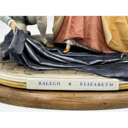 11 - A Capodimonte Ralegh & Elizabeth ceramic figurine signed B. Merli on wooden plinth - approx. 27cm hi... 