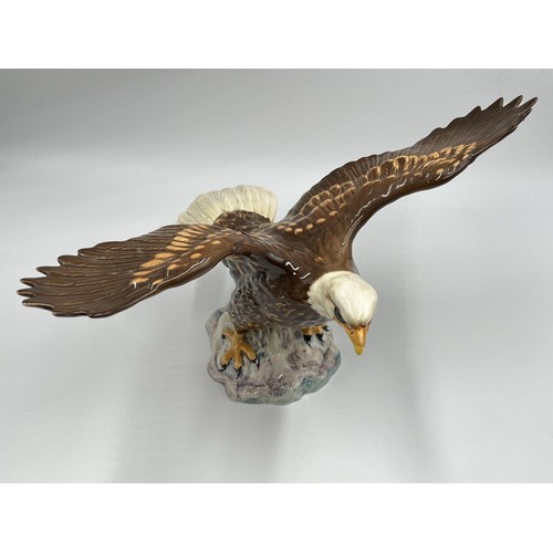 12 - A Beswick Bald Eagle ceramic figurine, model no. 1018 - approx. 19cm high x 33.5cm wide