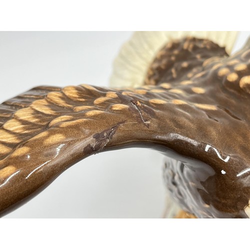 12 - A Beswick Bald Eagle ceramic figurine, model no. 1018 - approx. 19cm high x 33.5cm wide