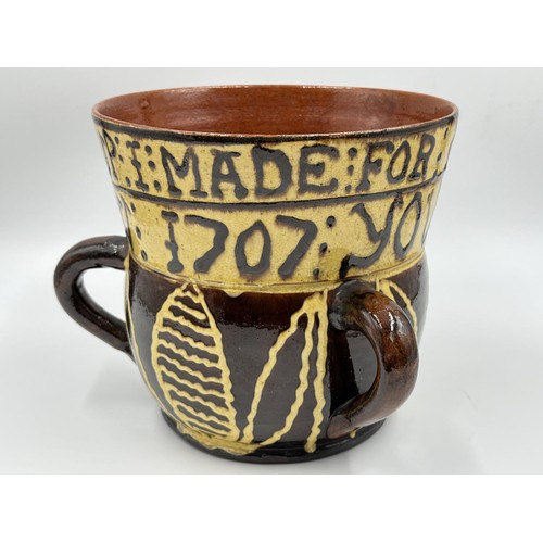 19 - A Wrotham style slipware loving cup - approx. 17.5cm high