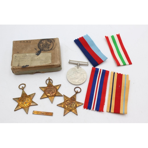 1074 - A boxed WWII medal group comprising Italy Star, Africa Star, 1939-45 Star and defence together with ... 