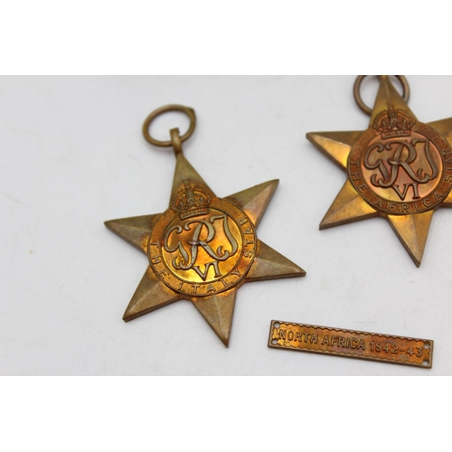 1074 - A boxed WWII medal group comprising Italy Star, Africa Star, 1939-45 Star and defence together with ... 