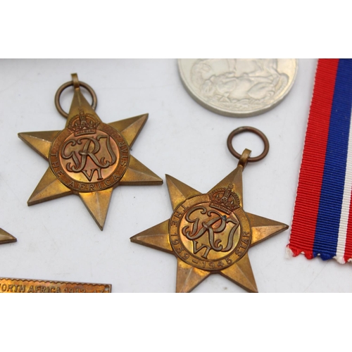 1074 - A boxed WWII medal group comprising Italy Star, Africa Star, 1939-45 Star and defence together with ... 