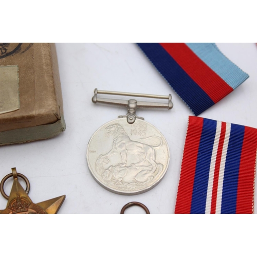 1074 - A boxed WWII medal group comprising Italy Star, Africa Star, 1939-45 Star and defence together with ... 