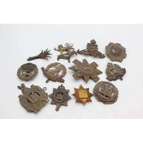 1081 - Twelve assorted vintage military cap badges to include Scottish, Norfolk Regt. Etc.