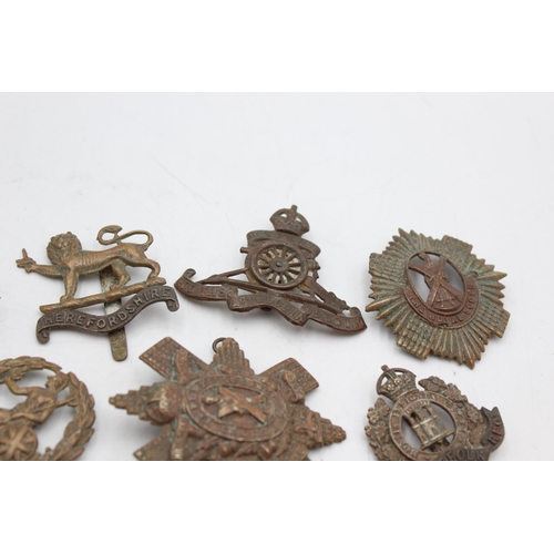 1081 - Twelve assorted vintage military cap badges to include Scottish, Norfolk Regt. Etc.