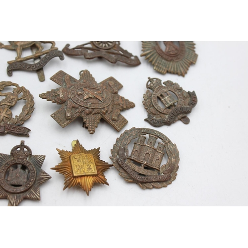 1081 - Twelve assorted vintage military cap badges to include Scottish, Norfolk Regt. Etc.