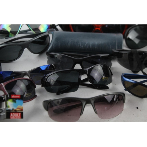 108 - A collection of assorted pairs of unisex sports style sunglasses to include Choppers, Revision, Uvex... 