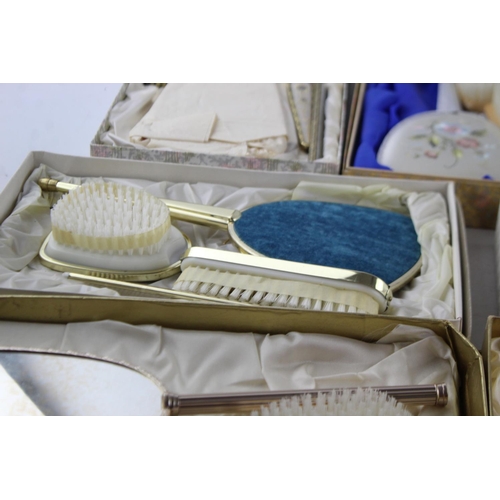 113 - Nine boxed vintage women's vanity dressing table mirrors and brushes sets