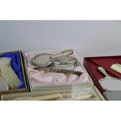 113 - Nine boxed vintage women's vanity dressing table mirrors and brushes sets