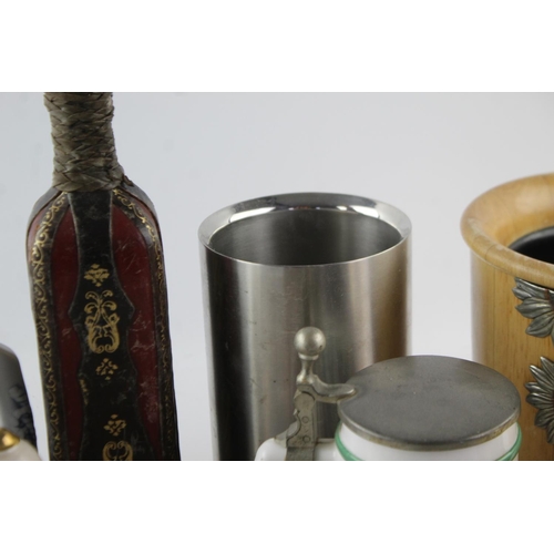 213 - A collection of antique and vintage brewing items to include Royal Selangor, decanters, steins etc.