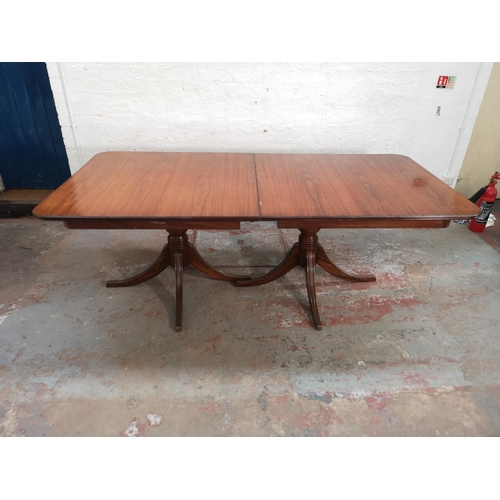 379 - A 19th century style simulated rosewood twin pedestal extending dining table