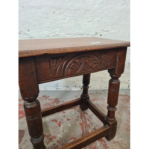 270 - A 17th century style solid oak rectangular joint side table with carved detailing - approx. 46cm hig... 