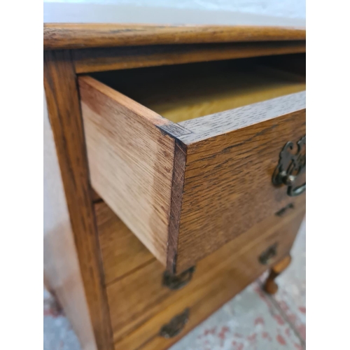 271 - A mid 20th century miniature oak chest of four drawers with cabriole supports - approx. 67cm high x ... 