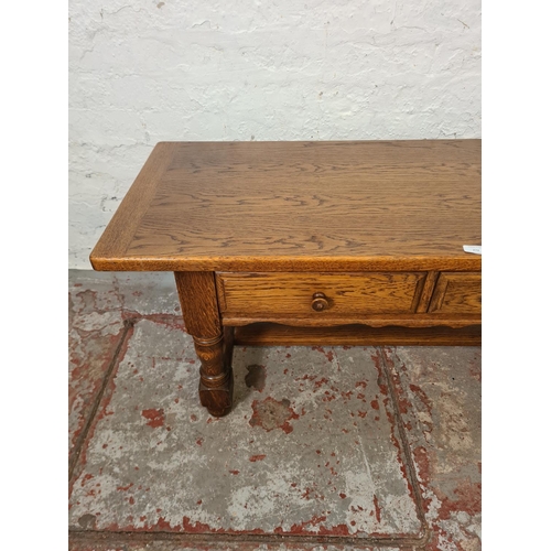 272 - A late 20th century solid oak two drawer rectangular coffee table with lower stretcher - approx. 50c... 