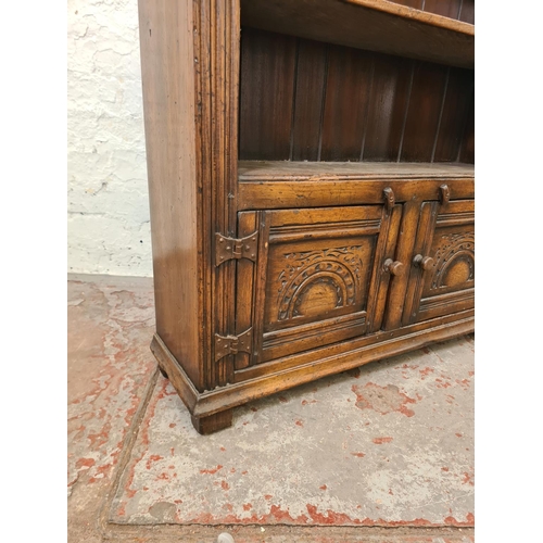 275 - A mid/late 20th century carved oak bookcase with two doors and two upper shelves - approx. 92cm high... 