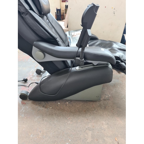 279 - An Inada W.1 black leatherette massage chair with operating manual and remote control