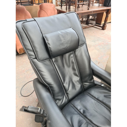 279 - An Inada W.1 black leatherette massage chair with operating manual and remote control