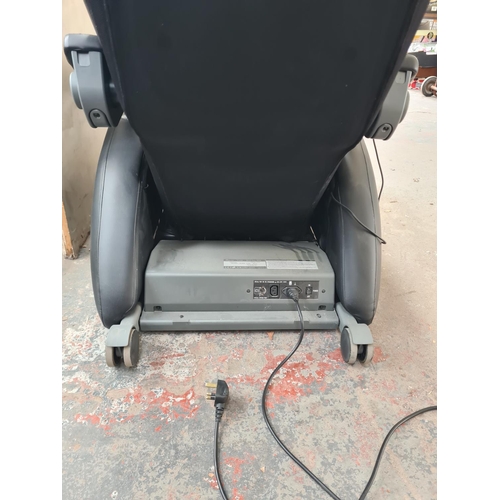 279 - An Inada W.1 black leatherette massage chair with operating manual and remote control