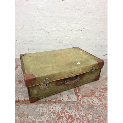 285 - An early 20th century Smith's Trunk Stores green canvas and brown leather travel trunk - approx. 25c... 