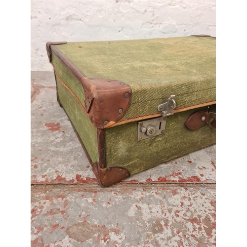 285 - An early 20th century Smith's Trunk Stores green canvas and brown leather travel trunk - approx. 25c... 