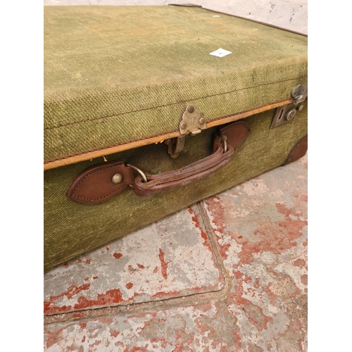 285 - An early 20th century Smith's Trunk Stores green canvas and brown leather travel trunk - approx. 25c... 