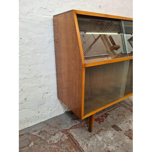 288 - A mid 20th century oak record cabinet with four glass sliding doors - approx. 88cm high x 92cm wide ... 