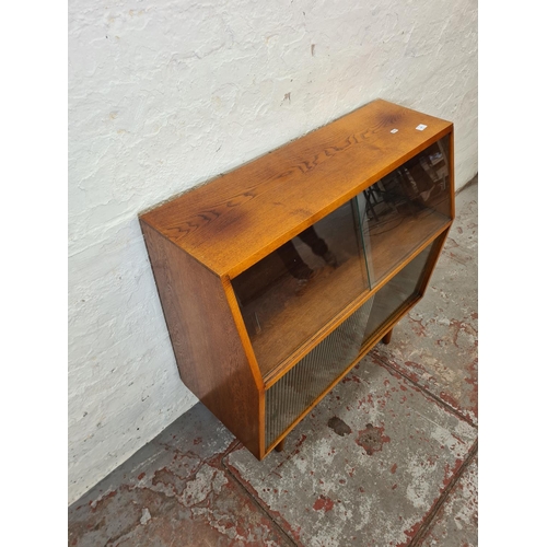 288 - A mid 20th century oak record cabinet with four glass sliding doors - approx. 88cm high x 92cm wide ... 