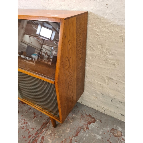 288 - A mid 20th century oak record cabinet with four glass sliding doors - approx. 88cm high x 92cm wide ... 