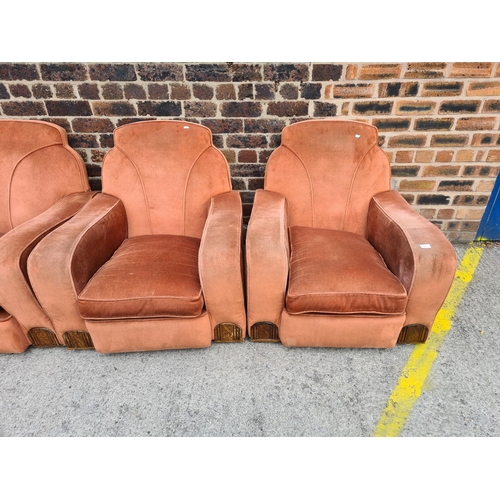 299 - An Art Deco salmon pink upholstered and carved oak three piece lounge suite comprising two armchairs... 