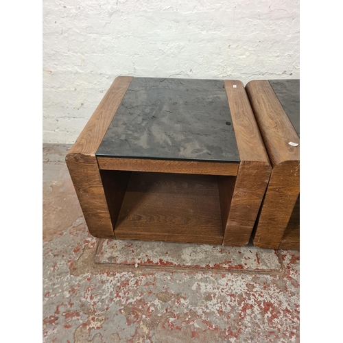 300 - A pair of modern oak effect and black glass square side tables - approx. 48cm high x 60cm²