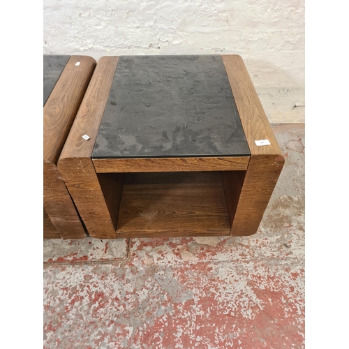 300 - A pair of modern oak effect and black glass square side tables - approx. 48cm high x 60cm²