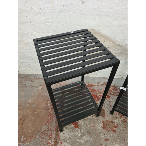 314 - A pair of modern black metal two tier side tables - approx. 65cm high x 36cm²