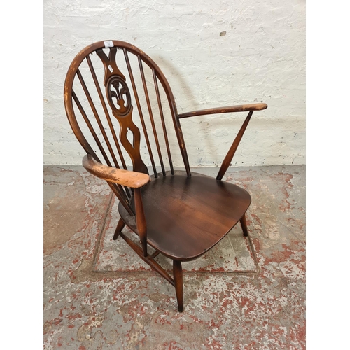 316 - An Ercol Fleur De Lys elm and beech armchair - approx.  82cm high x 69cm wide x 52cm deep