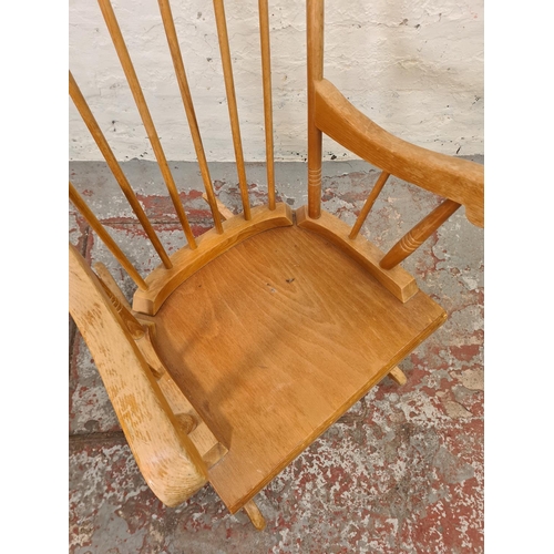 317 - A modern beech spindle back farmhouse rocking chair - approx. 96cm high x 55cm wide x 43cm deep