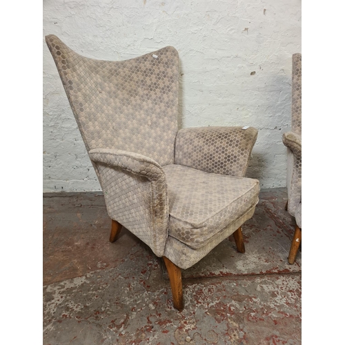 318 - A pair of mid 20th century grey upholstered and beech wing back armchairs - approx. 90cm high x 70cm... 