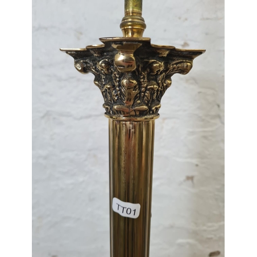 321 - A brass Corinthian column standard lamp with lion paw supports - approx. 156cm high