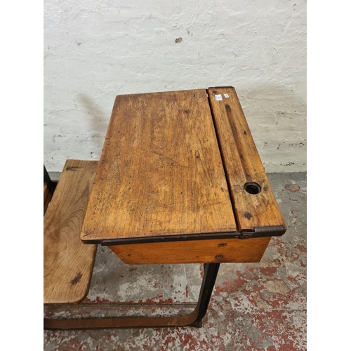 324 - An early 20th century elm and cast iron child's school desk and chair - approx. 74cm high x 62cm wid... 