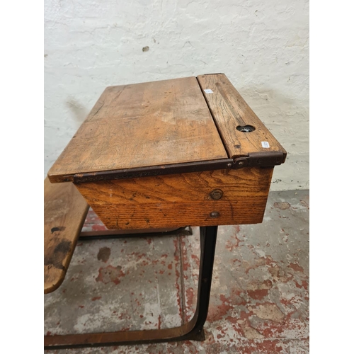 325 - An early 20th century elm and cast iron child's school desk and chair - approx. 74cm high x 62cm wid... 