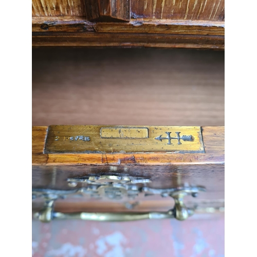 334 - An early 20th century Maple & Co. of London oak linen press with two upper cupboard doors, three int... 