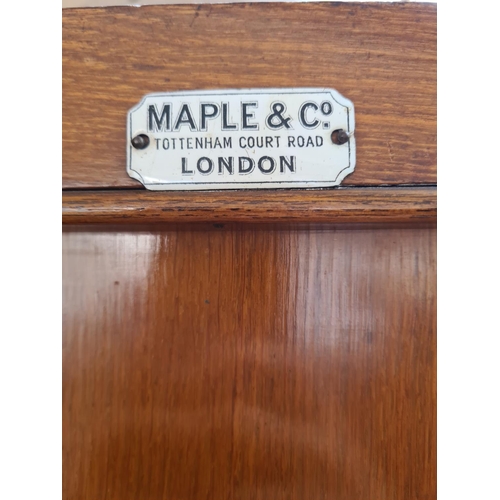 334 - An early 20th century Maple & Co. of London oak linen press with two upper cupboard doors, three int... 