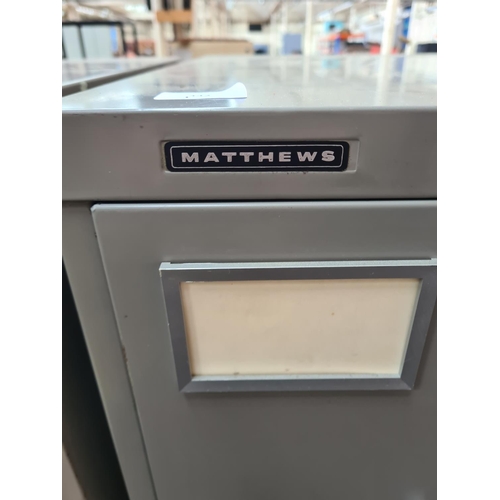 342 - A Matthews grey metal four drawer office filing cabinet - approx. 132cm high x 47cm wide x 62cm deep