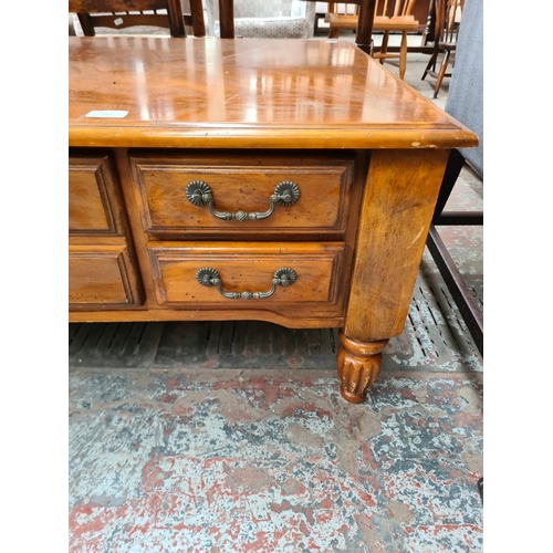 349 - A Klaussner cherry wood rectangular coffee table with five drawers - approx. 48cm high x 71cm wide x... 