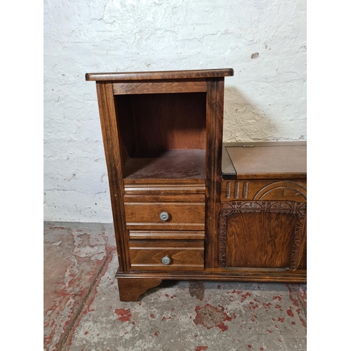 354 - An oak telephone seat with two drawers, hinged lid and lion design armrest - approx. 73cm high x 92c... 