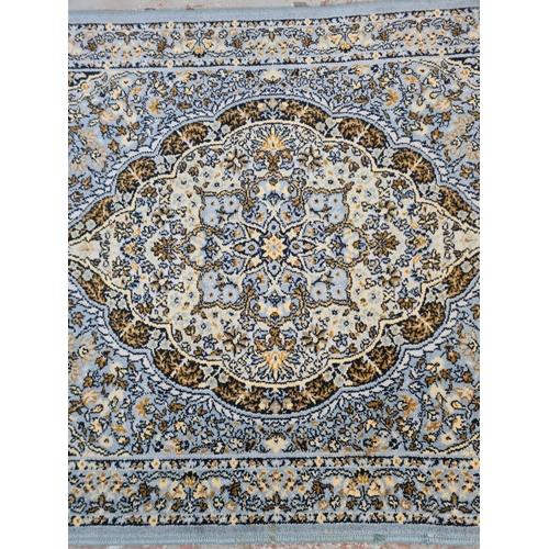 358 - A blue tasselled rug - approx. 175cm x 90cm