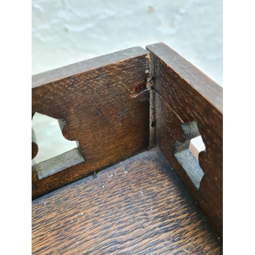 365 - An early 20th century oak bureau with fretwork galleried top, fall front, single drawer and two lowe... 